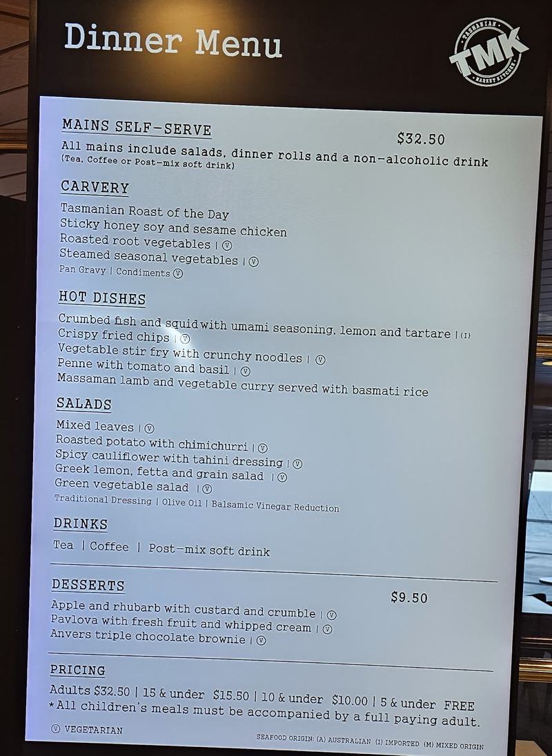 Eleven hours in a chair — The Dinner Menu board on the ship: mains self-serve $32.50 with carvery, hot dis