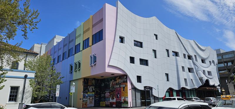 Six stops down Malop Street — Geelong Arts Centre — a draped white concrete facade beside a stack of pastel-co