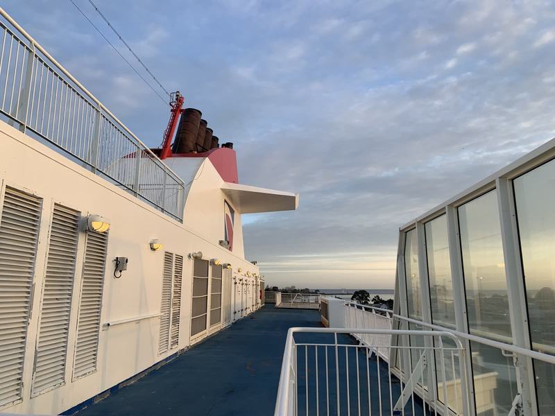 Eleven hours in a chair — The outer deck alongside the ship's funnel, white superstructure and railings un