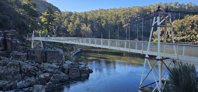 A gorge at the end of the street β The Alexandra Suspension Bridge, cream ironwork with dark red trim, spanning the
