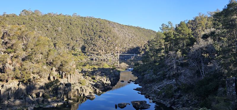 A gorge at the end of the street β The gorge looking downstream, cliffs on both sides, the suspension bridge small