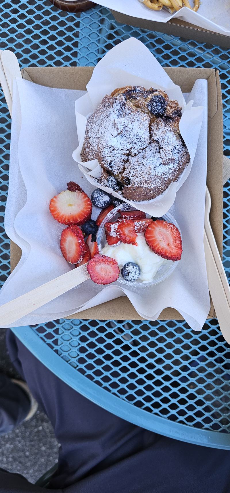 A gorge at the end of the street β A blueberry muffin dusted with icing sugar beside a pot of organic yoghurt with