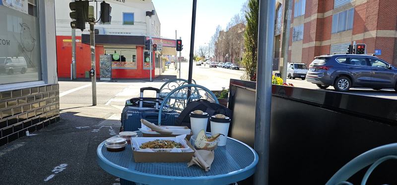 A gorge at the end of the street β The same table from the other side, looking down the street to a red shopfront a
