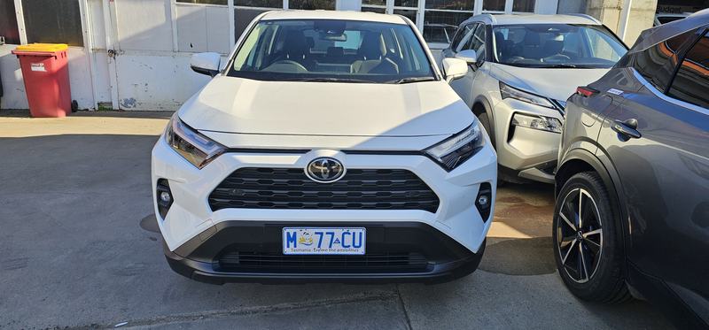 Weindorfer's mountain — A white Toyota RAV4 in the Budget yard on Wellington Street, Launceston