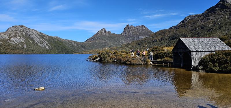 Weindorfer's mountain — The weathered timber boat shed at Dove Lake, Cradle Mountain behind, people on t