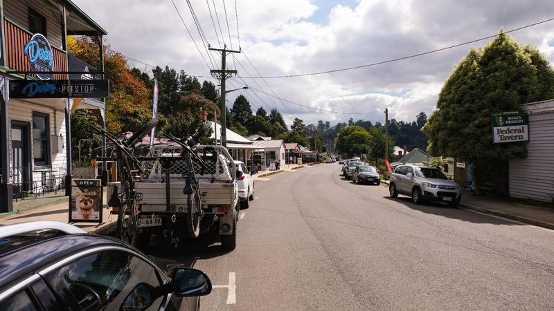 Tin, lavender and the Chinese of Weldborough — Derby's main street: weatherboard shops, a pub sign, a ute with mountain bikes o