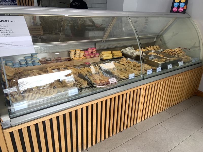 Up the Tamar — The display cabinet at the Tasman Fish & Chip Co: trays of battered fish, potato