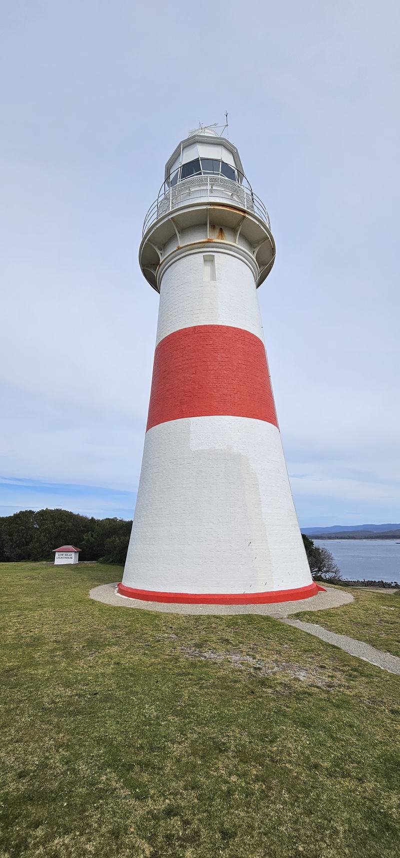 Up the Tamar — Low Head lighthouse from the foot of the tower: white with a red band, a small w
