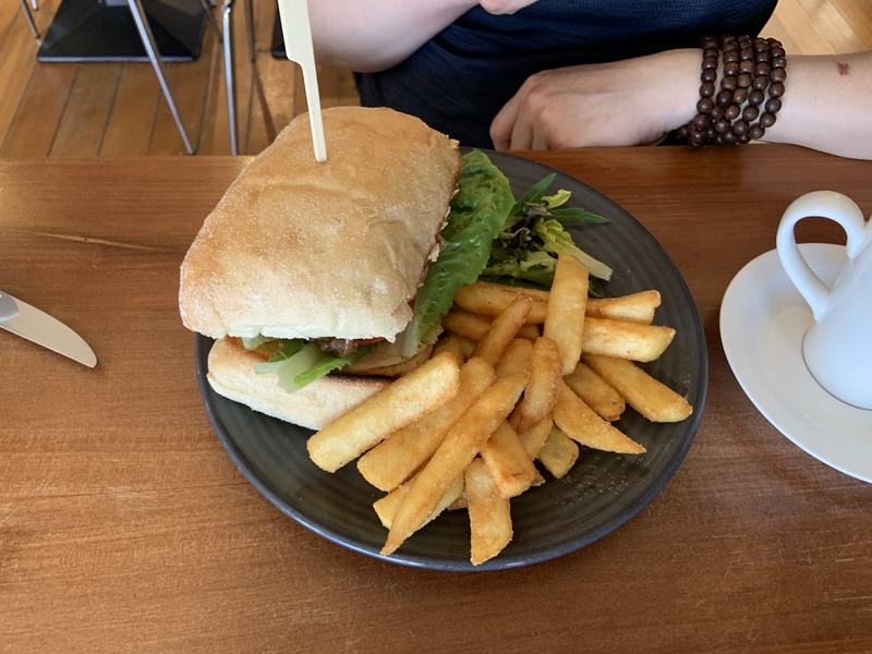 Why it's called Wineglass Bay — A sandwich held together with a skewer beside a pile of chips and a little salad