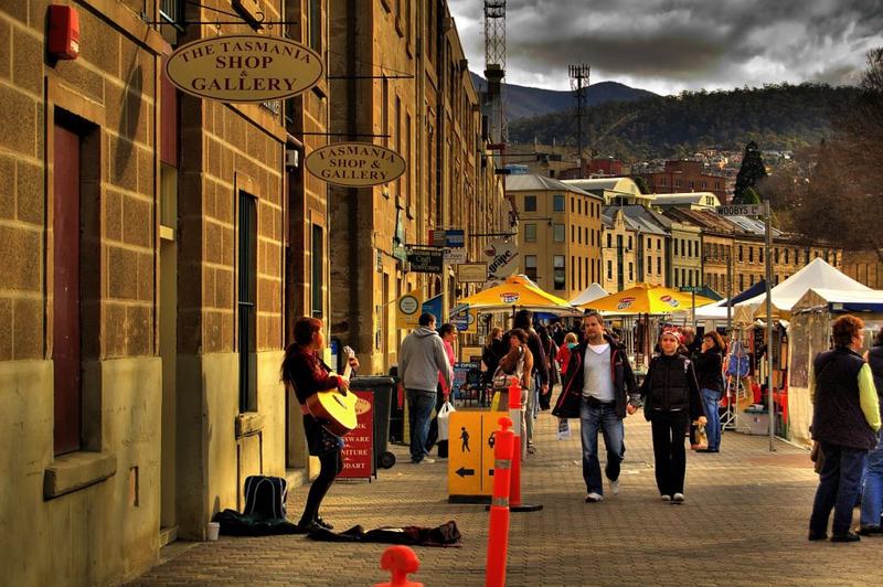 Cut into the cliff β Salamanca Market on a Saturday morning: stalls and umbrellas in front of the san