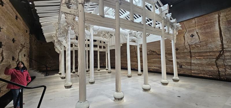 Cut into the cliff β A Chinese timber hall frame painted white, its columns resting on glass balls, i