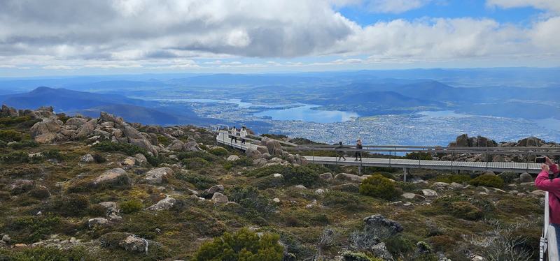 A mountain with four names — The summit boardwalk crossing the rocks and alpine scrub, people walking along i