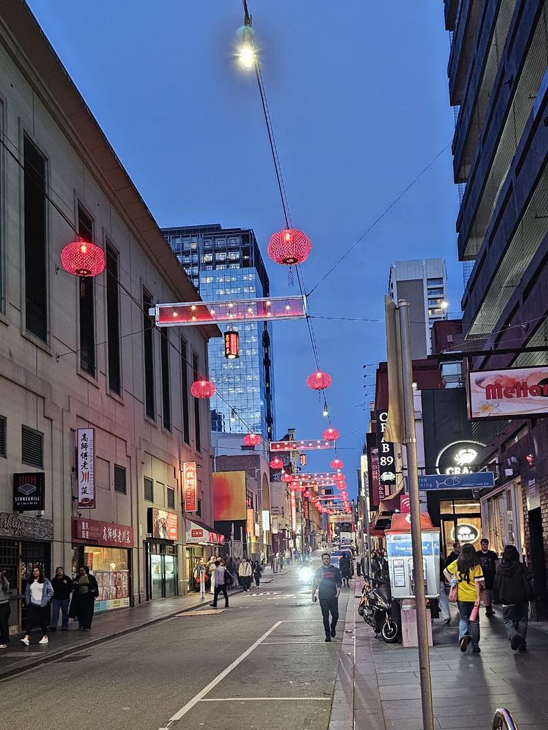 Melbourne anytime — a base, not a checklist — Little Bourke Street at dusk, red lanterns strung across the street, restaurants