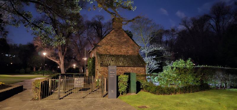 Melbourne anytime — a base, not a checklist — A small brick cottage with a steep tiled roof and chimney behind a wrought-iron