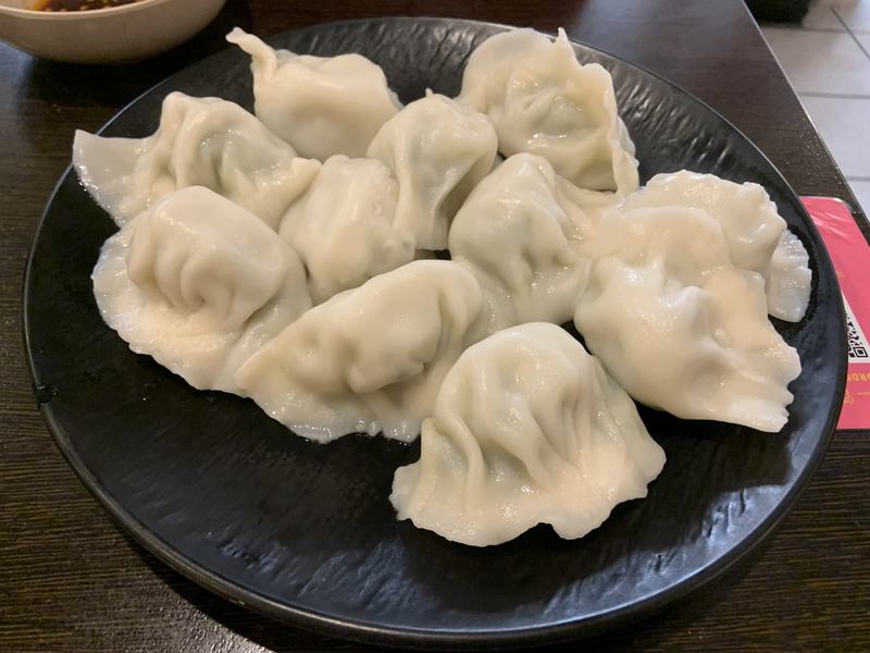 Melbourne anytime — a base, not a checklist — A black plate of boiled dumplings on a dark table