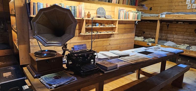The city that faces south — The long table in the Mawson's Huts replica, with a gramophone and horn, a typew