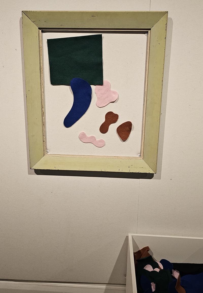 Hobart anytime — a base, not a checklist — An empty wooden frame on a gallery wall with green, blue, pink and brown felt sh