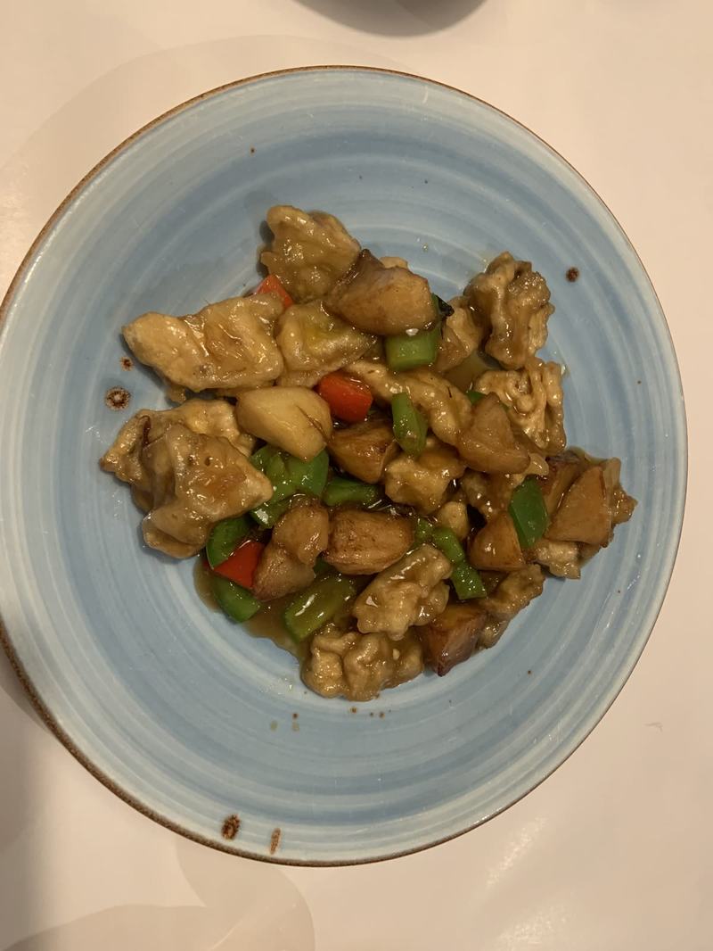 What the gold paid for — Stir-fried chicken pieces with green and red capsicum in a brown sauce on a roun